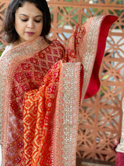 Red, Orange Handwoven NeemZari Bareek Bandhani with Gotapatti Handwork in Pure Georgette